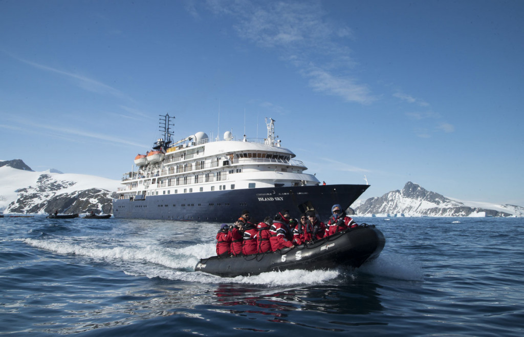The exterior of the luxury cruise ship The Island Sky with an expedition zodiac pictured